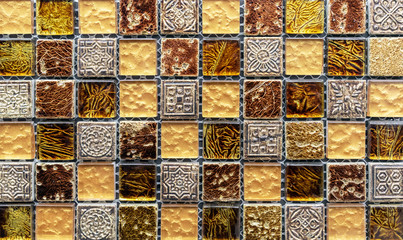 Ceramic mosaic tiles with yellow and brown embossed squares to decorate the kitchen, bathroom or pool.
