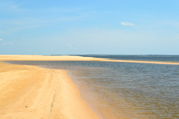 Interesting and particular river landscape in Brazil, in the state of Parà. A beach of clear sand and varying tongues of land depending on the movements of the water on the Amazon River.