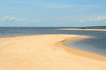Interesting and particular river landscape in Brazil, in the state of Parà. A beach of clear sand and varying tongues of land depending on the movements of the water on the Amazon River.