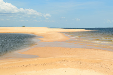 Fototapeta na wymiar Interesting and particular river landscape in Brazil, in the state of Parà. A beach of clear sand and varying tongues of land depending on the movements of the water on the Amazon River.