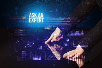 Businessman touching huge screen with ASK AN EXPERT inscription, cyber business concept