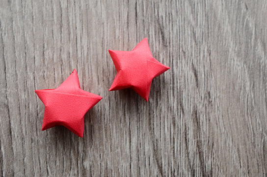 Two Red Origami Luckly Stars On Wooden Background