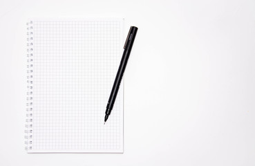 Squared notebook with black pen on a white background. Record ideas, notes, plans, tasks.  Notebook top and side view. Flatlay. Copy Space