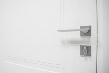 Metal doors knob handle on modern interior