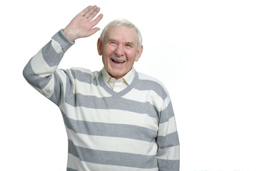 Very happy senior old grandfather is laughing heartily. Cheeful grandpa raising right hand up in white isolated background.