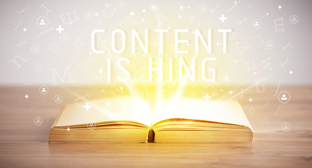 Open book with CONTENT IS KING inscription, social media concept