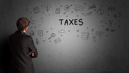 businessman drawing a creative idea sketch with TAXES inscription, business strategy concept