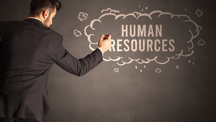 businessman drawing a cloud with HUMAN RESOURCES inscription inside, modern business concept