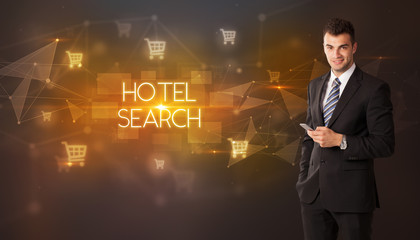 Businessman with shopping cart icons and HOTEL SEARCH inscription, online shopping concept