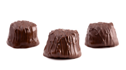 Three Dark Chocolate Truffles in a Row on a White Background