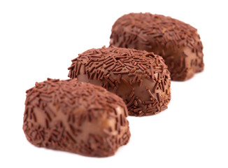 Three Milk Chocolate Truffles in a Row on a White Background