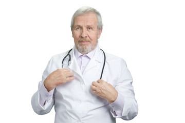 Old physician with stethoscope portrait. White doctor uniform. Isolated background.