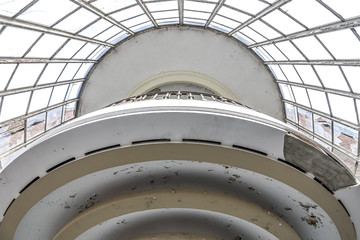 Fototapeta premium Bottom view of a balcony in round white cream colors, lots of light.