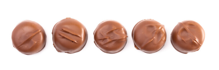 Five Milk Chocolate Truffles in a Row on a White Background