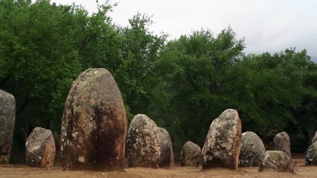 Pan left Almendres Cromlech menhir stones, ancient site, Portugal
