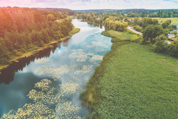 Top view of a river in the countryside on a sunny day. Nature landscape with a beautiful cloudy sky. In summer