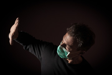 Portrait of  sick caucasian man with medical mask. Coronavirus Covid-19 concept. Black background 