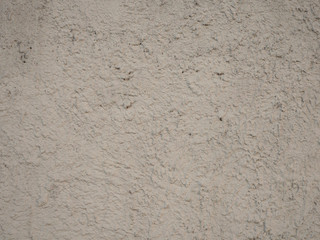 White stone concrete wall with roughness and smudges from paint, abstract background.