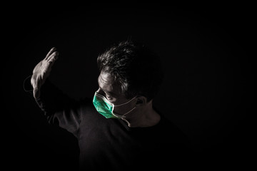 Portrait of  sick caucasian man with medical mask. Coronavirus Covid-19 concept. Black background 