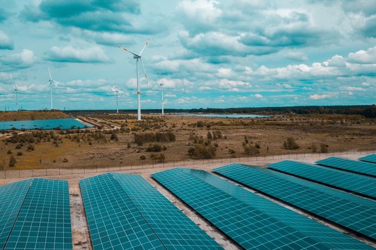 Solar panels and windmills in a green energy park.