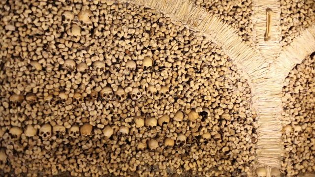 Chapel of Bones wall, skeletons, skulls, church, pan left, Evora, Portugal