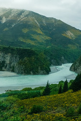 turquoise river flowing in the southern alps mountains