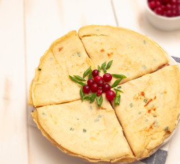 Salty pancakes with cheese and green onions decorated with cranberries. Pancakes for Shrovetide