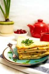 Salty pancakes with cheese and green onions. Pancakes for Shrovetide