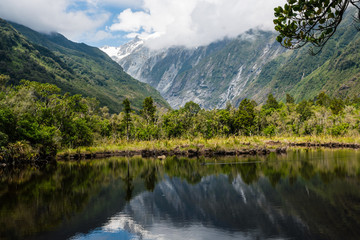 peter's pool - lake in the mountains at franz josef glacier