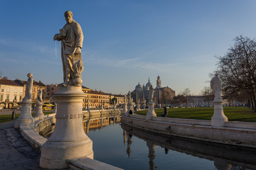 Statues at the largest square in the city of Padova known as Prato della Valle are reflected on the water of the canal - obrazy, fototapety, plakaty