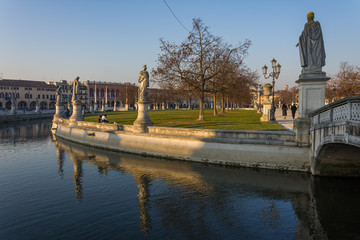 Statues at the largest square in the city of Padova known as Prato della Valle are reflected on the water of the canal