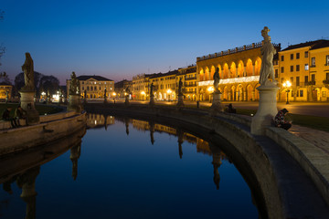 Fototapeta na wymiar Statues at the largest square in the city of Padova known as Prato della Valle are reflected on the water of the canal