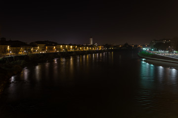 Fototapeta na wymiar View of Verona and the Adige river from the Castelvecchio bridge, also known as the Scaliger bridge at night