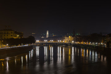 View of Verona and the Adige river from the Castelvecchio bridge, also known as the Scaliger bridge at night