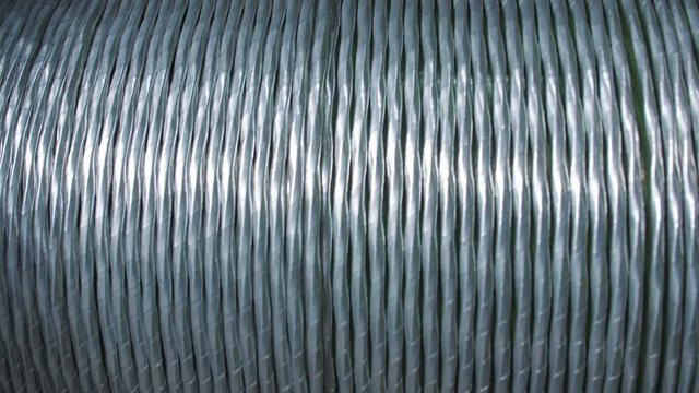 Aluminum wire pulley rolling. Winding the aluminum cable onto the reel.