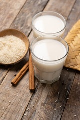 Mexican rice horchata with cinnamon on wooden background