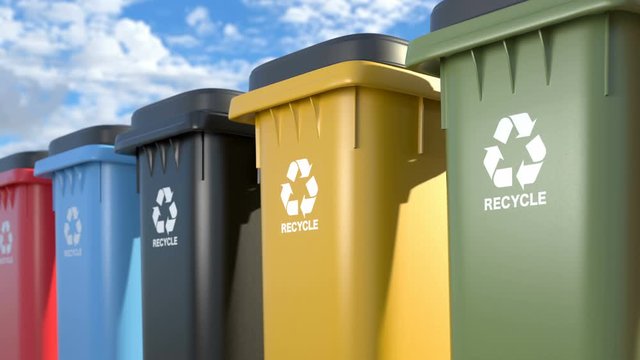Colorful plastic trash cans with a logo recycling looped animation on a blue sky background. Symbol of recycling, waste sorting and saving the environment. 4k, Ultra HD 3840x2160