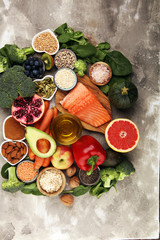 Fototapeta na wymiar Healthy food clean eating selection: fish, fruit, vegetable, cereal, leaf vegetable on rustic background