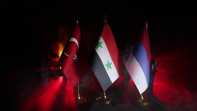 Closeup, flags on dark background. Concept of crisis of war and political conflicts between nations. Selective focus