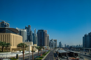 Fototapeta na wymiar blue, sky, Sunny, day, space, distance, panorama, city, street, palm trees, houses, high-rises, skyscrapers, buildings, structures, concrete, glass, reflections, road, metro, style, architecture, walk