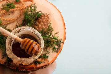 composition with honey, spoon and tree bark
