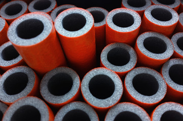 Red construction foam tubes objects background