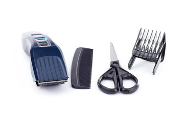 Set of hairdressing tools for cutting hair and beard on a white background. Scissors, hair clipper and comb.