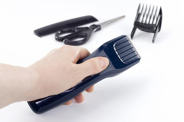 Hair clipper in hand. Barber tools on a white background.