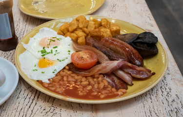 A hearty full English breakfast on a table.