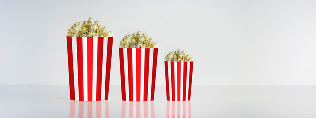 Popcorn box isolated on clean natural background. Good for watching cinema and movies. Delicious but unhealty nutrition.