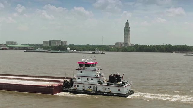 Aerial: Barge on the Mississippi River & downtown Baton Rouge. Louisiana, USA