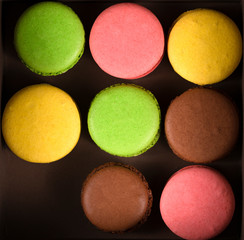 colored macaroons in a box on top