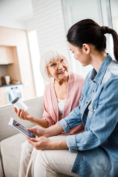 Old Lady Discussing Medicaments With Daughter And Doctor