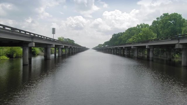 Swamp river and Interstate 10 Freeway cutting through it. New Orleans, Louisiana, USA